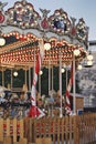 Empty vintage carousel horses during traditional Christmas fairy market, closeup.