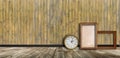 Empty vintage frames and watch against an wooden wall Royalty Free Stock Photo