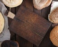 Empty vintage kitchen cutting board and various loaves of bread