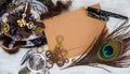 An empty vintage postcard for a close-up message, surrounded by women`s jewelry, lace with fur and steampunk gears mechanisms and