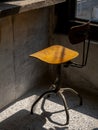 Empty vintage spinning chairs backrest, round seat decorated on concrete wall background.