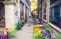 Empty vintage terrace in historical downtown with multi-colored chairs on the pavement sidewalk. Colorful chairs in retro