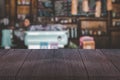 Empty vintage wooden table in font of blurry counter bar of coffee shop. Abstract background with copy space. Product display Royalty Free Stock Photo