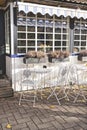 Vintage wrought iron garden table and chairs in public cafe in an autumnal garden