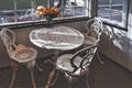 Empty vintage wrought iron garden table and chairs in public cafÃÂ© inside an autumn day Royalty Free Stock Photo