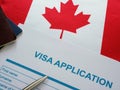 Empty visa application form and Canada flag.