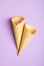 Empty wafer cone. Sweet ice cream cornet on violet background. Top view