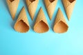 Empty wafer ice cream cones on blue background, flat lay. Space for Royalty Free Stock Photo