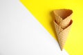 Empty wafer ice cream cones on color background. Space for text Royalty Free Stock Photo