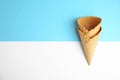 Empty wafer ice cream cones on color background, flat lay Royalty Free Stock Photo