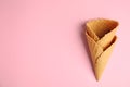 Empty wafer ice cream cones on pink background, flat lay. Royalty Free Stock Photo