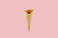 Empty waffle ice cream cone on soft pastel pink background, mock up for advertising, design, menu, summer food. Royalty Free Stock Photo