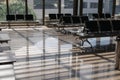 Empty waiting hall at airport or train station on sunny day. Concept of tourism, quarantine, isolation, losses of transport Royalty Free Stock Photo