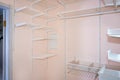 Empty walk-in closet with shelves. Dressing room Interior elements. Royalty Free Stock Photo