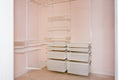 Empty walk-in closet with shelves. Dressing room Interior elements. Royalty Free Stock Photo