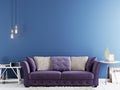 Empty wall for mock up on a blue wall in modern hipster interior with violet sofa and white table. Royalty Free Stock Photo