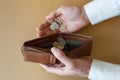 Empty wallet in the hands of a man on a plain background Royalty Free Stock Photo