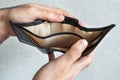 Empty wallet without money in male hands. The concept of poverty, financial problems Royalty Free Stock Photo