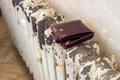 Empty wallet on an old shabby radiator, Concept Living in poverty, Rising energy prices, Social inequality, Inflation affecting