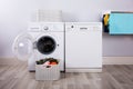 Empty Washing Machine With Pile Of Dirty Clothes Royalty Free Stock Photo