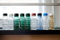 empty water bottles lined up on a shelf Royalty Free Stock Photo