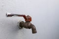 The empty water tap next to the wall shows the drought Royalty Free Stock Photo