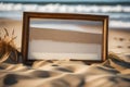 An empty, weathered photo frame half-buried in the sand on a deserted beach, with waves gently crashing in the background