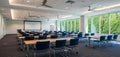 Modern conference room with natural light and projector screen for meetings Royalty Free Stock Photo