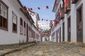 A colonial architecture street adorned with flags for the Divine Holy Spirit Festivity in Paraty, Brazil. Royalty Free Stock Photo