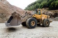 empty wheel loader machine loading gravel. Industrial machinery working with rock breaker and crusher