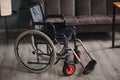 Empty wheelchair in black with large wheels and manual controls on home background. Barrier-free area. Nobody. Apartment