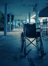 Empty wheelchair and hospital background, feels lonely and quiet.