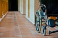 Empty wheelchair in hospital corridor Royalty Free Stock Photo