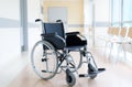 Empty wheelchair in hospital corridor Royalty Free Stock Photo