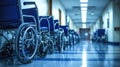 Empty wheelchair in hospital parking at corridor near a row of chairs for patient Royalty Free Stock Photo