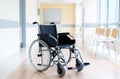 Empty wheelchair in hospital corridor Royalty Free Stock Photo