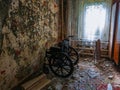 Empty wheelchair in old abandoned house Royalty Free Stock Photo