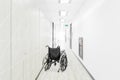 Empty wheelchair parked in hospital hallway Royalty Free Stock Photo