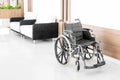 Empty wheelchair parked in hospital hallway Royalty Free Stock Photo