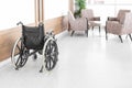 Empty wheelchair parked in hospital hallway Royalty Free Stock Photo