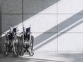 Empty Wheelchair on wall Background with shadow lighting