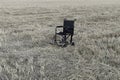 Empty wheelchair in a wide meadow. disabled carriage in nature. medical equipment for invalid Royalty Free Stock Photo