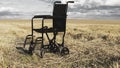 Empty wheelchair in a wide meadow. disabled carriage in nature. medical equipment for invalid person Royalty Free Stock Photo