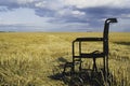 Empty wheelchair in a wide meadow. disabled carriage in nature. medical equipment for invalid person Royalty Free Stock Photo