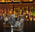 Empty whiskey glasses with ice on bar table Royalty Free Stock Photo