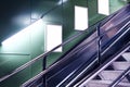 Empty white advertising urban billboard indoor in subway hall, vertical portrait, green walls, above metallic stairs.