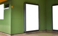 Empty white advertising urban billboard indoor in subway hall, vertical portrait, green walls. Royalty Free Stock Photo