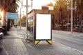 Empty white advertising urban billboard near city bus stop, placeholder template on a street, space for design layout. sunset. Royalty Free Stock Photo