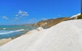 Empty white beach with old ruins of abandoned stone house on the rocks and summer blue sky and sea in background in Sicily Italy Royalty Free Stock Photo