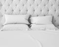 Empty white bed and pillows with luxury headboard Royalty Free Stock Photo